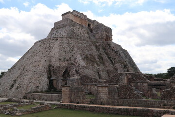 Fototapeta na wymiar Pyramid of the Magician, Piramide del Advino next to the Cuadrangulo de los Pajaros, Quadrangle of the birds, Uxmal, Merida, Mexico