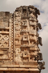 Elaborate decor, faces, masks on the edge of a building in the Cuadrangulo de las Monjas, Quadrangle of the Nuns, Uxmal, Merida, Mexico © Anja