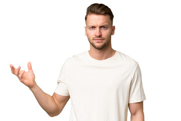 Young blonde caucasian man over isolated background making doubts gesture