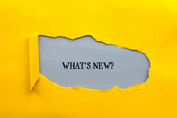 What's new? question lettering on ripped yellow paper with gray background. Conceptual photo. Top...