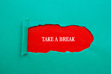 Take a break lettering on ripped blue paper with red background. Conceptual photo. Top view, copy...