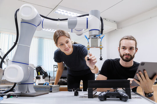 automation machine engineer students study and inspection control robot arm machine in robotics engineering academy at university or factory workshop. AI robot technology, future innovation trend.