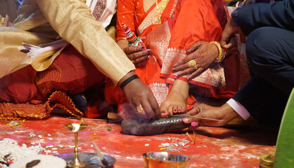 Closeup of indian hindu couple holding each other hands during marriage symbolizing love...