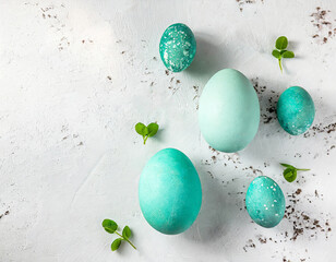 Easter eggs in mint green colour on white grunge background with copy space
