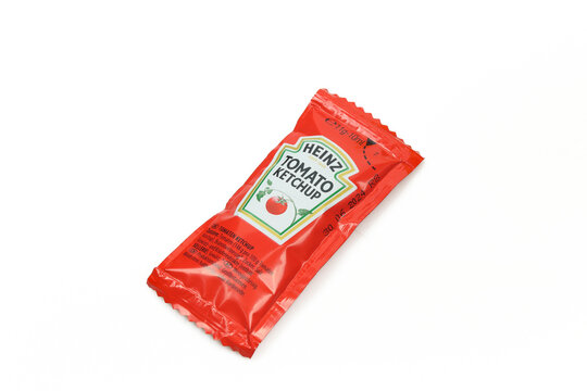 Small 10ml Heinz tomato ketchup packet isolated on white background
