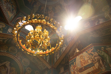 SOFIA, BULGARIA - 30 JULY 2023: Sunlight shine through church ceiling Beautiful colorful Orthodox Church and chandelier