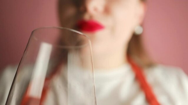 Luxury gorgeous woman drinking red wine at wine tasting event, drink and enjoying testing the quality of a popular blend. High quality FullHD footage