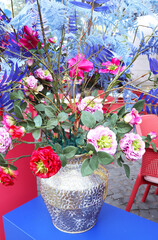 blue floral background. colorful flowers in a vase on a blue background