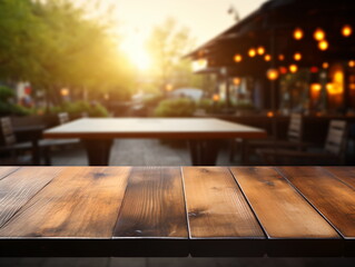 An empty wooden table in front of a blurred restaurant background