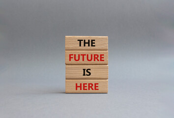 The future is here symbol. Concept words The future is here on wooden blocks. Beautiful grey background. Business and The future is here concept. Copy space.