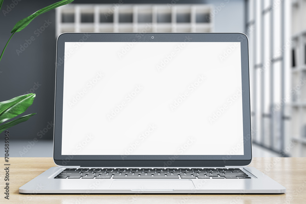Poster Modern designer office desk with empty white mock up laptop screen and other items on blurry office background. 3D Rendering.