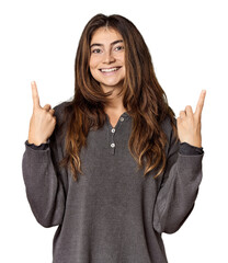 Young Caucasian woman in studio setting indicates with both fore fingers up showing a blank space.