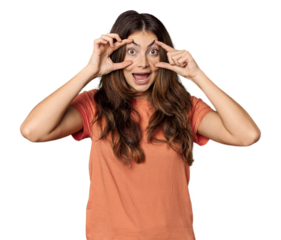 Young Caucasian woman in studio setting keeping eyes opened to find a success opportunity.