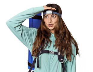 Young Caucasian woman with mountain gear & headlamp