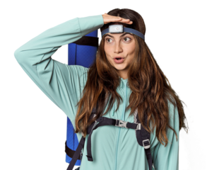 Young Caucasian woman with mountain gear & headlamp
