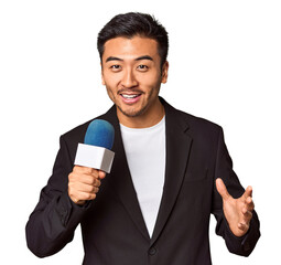 Young Chinese TV presenter reporting news with microphone in studio