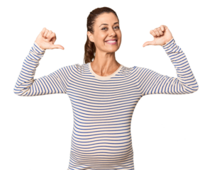Pregnant middle-aged woman in studio setting feels proud and self confident, example to follow.