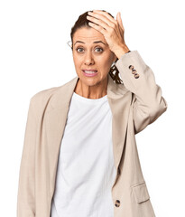 Entrepreneur in business attire, studio portrait being shocked, she has remembered important...