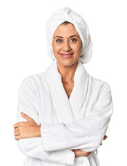 Middle-aged woman in bathrobe and towel looking at camera