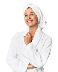 Middle-aged woman in bathrobe and towel looking at camera