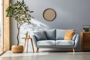 A stylish living room with a blue sofa, a coffee table, and a plant