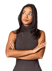 Young Filipina with long black hair in studio dreaming of achieving goals and purposes