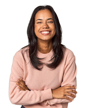Young Filipina with long black hair in studio laughing and having fun.