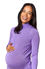 Radiant young pregnant Filipina woman in studio