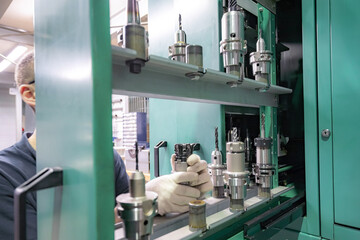 Metal-cutting cutters for a CNC machine in a tool rack.