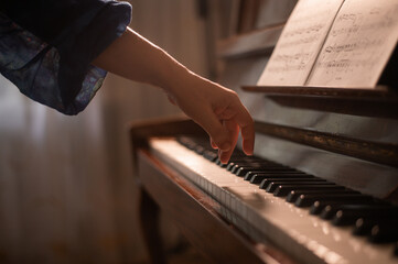 a pianist's hand is on the piano keys