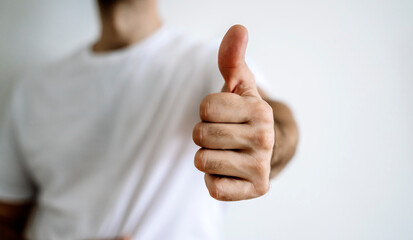 Man shows like on a blank background. Hand with like symbol. Luck, success concept.