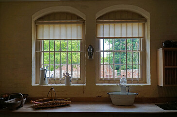 Vintage Kitchen Bared Windows with worktop and jugs.