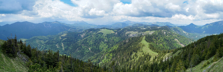 Idyllic panoramic view: Small green hills and steep snowy mountains in Ötscherland, Lower Austria