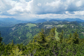 Fototapeta na wymiar Small green hills and steep snowy mountains in Ötscherland, Lower Austria