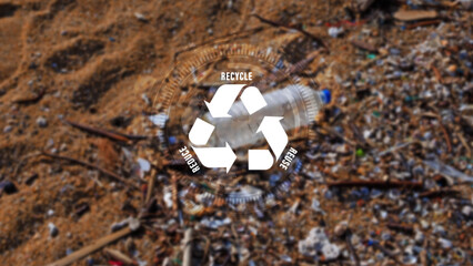 Reduce, reuse, recycle symbol on Plastic water bottles are left on the beach as waste polluting nature, ecological metaphor for ecological waste management and sustainable and economical lifestyle.