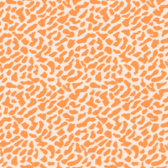 Ikat texture leopard spots in apricot color on bright background. Seamless pattern can be used as all-over print for pajamas, fabrics, wallpapers, diaries, school exercise books, wrapping, decoration
