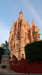 The beautiful church/cathedral Parroquia de San Miguel Arcangel with the statue of Fray Juan de San...