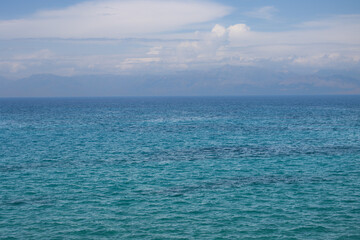 Obraz premium Ionian sea and a cloudy sky above mountains, Corfu, Greece