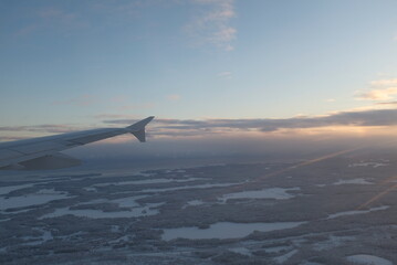 Flying over  white snowy landscape with many forests in Finland