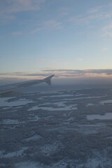 Flying over  white snowy landscape with many forests in Finland