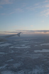 Flying over  white snowy landscape with many forests in Finland