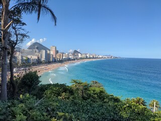 the beautiful beach and skyline from a hill by the water