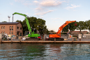 Orange and green crane. Construction works