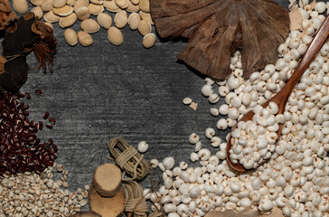 Ingredients for a Chinese soup, a Chu Shin soup, lie next to each other against a dark background. The pulses and mushrooms form a frame around a text field.