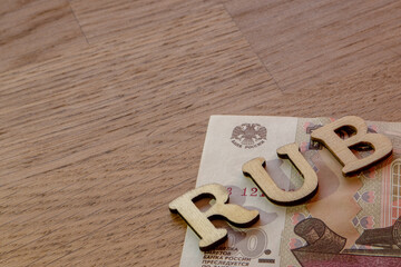 Russian ruble theme, ruble word concept made of wooden letters rub on wooden background