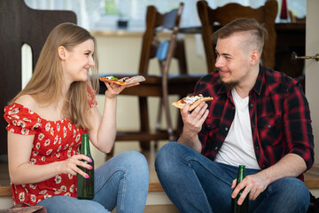 A smiling young couple spends time together at home.