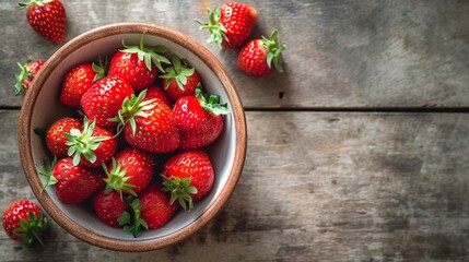Ripe strawberries forest fruits in wooden bowl on wooden table. Fresh strawberry top view with copy space.