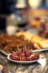 Red grapes for breakfast on the table. Fruit on a bowl at a celebration with cake