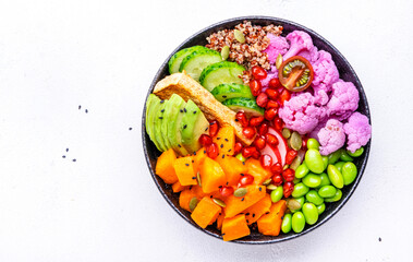 Vegan buddha bowl with pumpkin, quinoa, avocado, edamame, tofu, cauliflower, pomegranate and sesame...