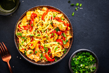 Stir fryed egg noodles with chicken, pineapple, paprika, green onion, soy sauce and sesame seeds in...